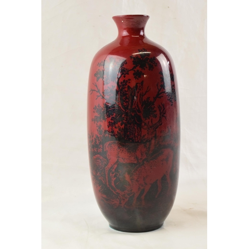 157 - Royal Doulton flambe vase in the Woodcut design with deer amongst woodland, 28cm tall.