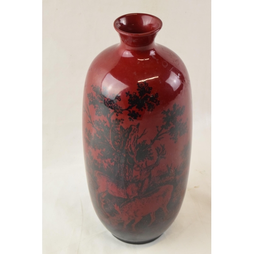 157 - Royal Doulton flambe vase in the Woodcut design with deer amongst woodland, 28cm tall.