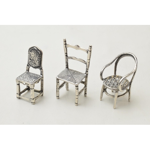 168O - A trio of miniature silver chairs, 13.1 grams, tallest 35mm (3).