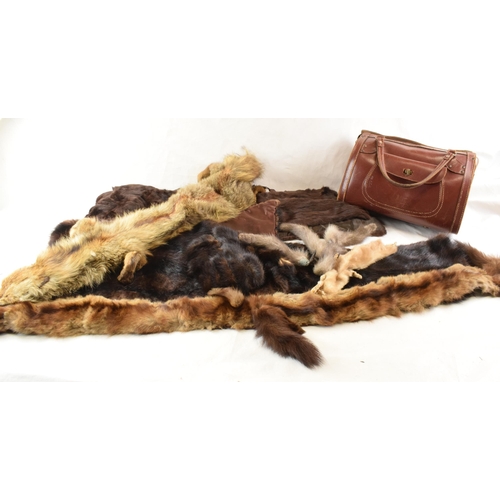 452C - A quantity of vintage furs, stoles and other items together with a vintage leather handbag.