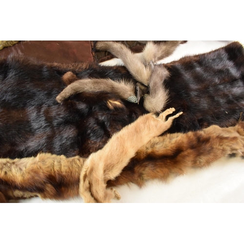 452C - A quantity of vintage furs, stoles and other items together with a vintage leather handbag.