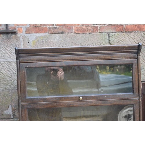 488 - Early 20th century three section barrister's bookcase with sliding doors with brass knobs, Globe Wer... 