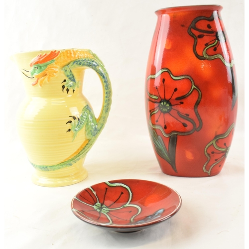 73 - A Poole Pottery vase together with Poole pin tray and a Burleigh Ware dragon handled vase. (3)