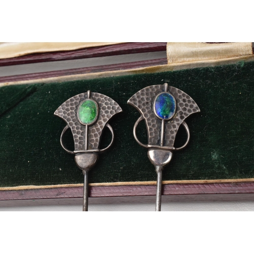 168Q - Cased pair of Art Nouveau hat pins with enamelled decoration and hammered Liberty style elements, lo... 