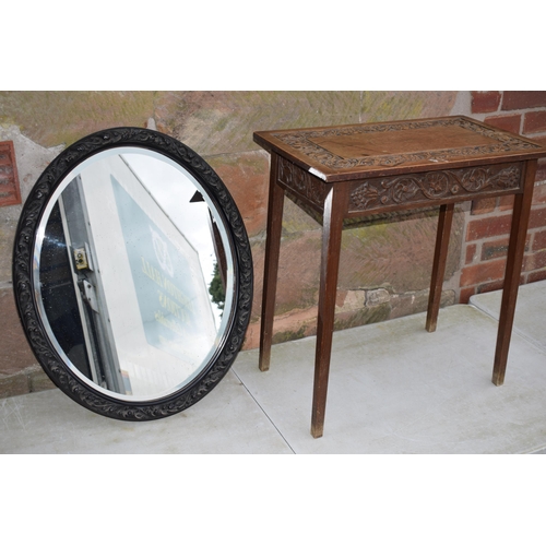 495 - Vintage 1930s oak side table with carved decoration together with am ebonised carved oval mirror, 72... 