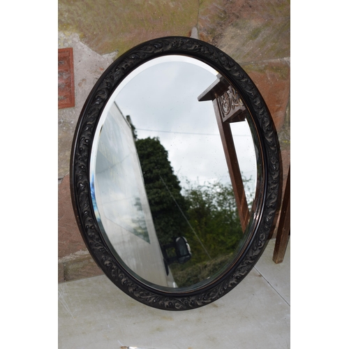 495 - Vintage 1930s oak side table with carved decoration together with am ebonised carved oval mirror, 72... 