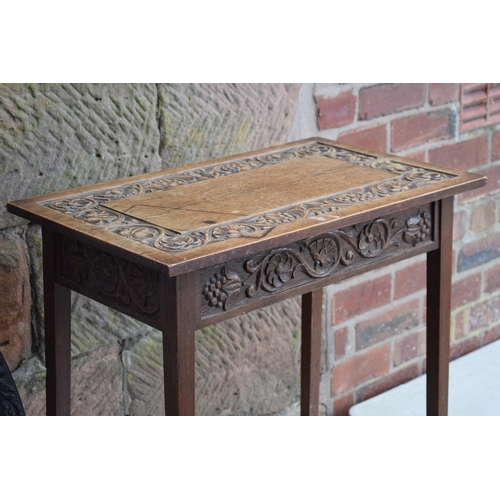 495 - Vintage 1930s oak side table with carved decoration together with am ebonised carved oval mirror, 72... 