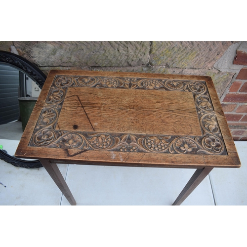 495 - Vintage 1930s oak side table with carved decoration together with am ebonised carved oval mirror, 72... 