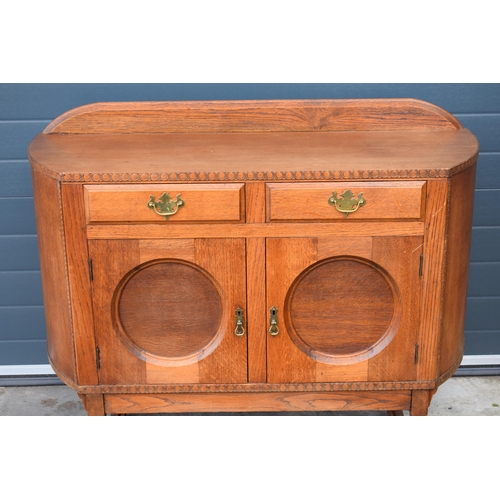 501 - 1930s Art Deco oak sideboard with shaped front, 122x45x99cm tall.