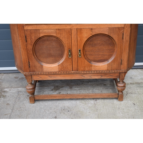 501 - 1930s Art Deco oak sideboard with shaped front, 122x45x99cm tall.