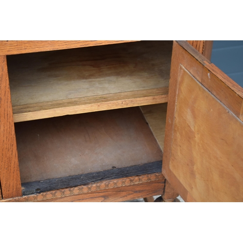 501 - 1930s Art Deco oak sideboard with shaped front, 122x45x99cm tall.