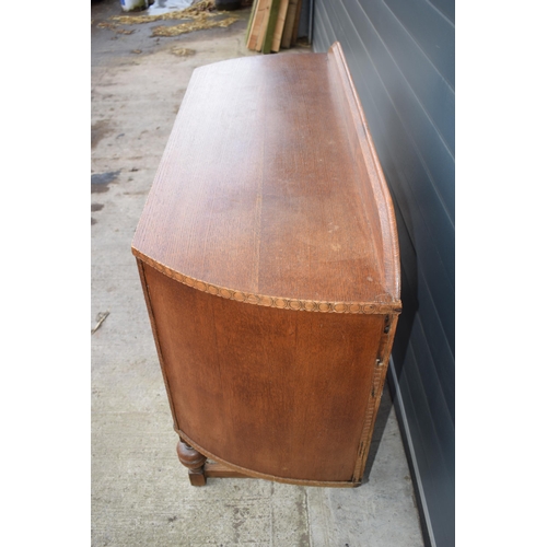 501 - 1930s Art Deco oak sideboard with shaped front, 122x45x99cm tall.