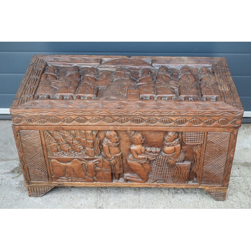 503 - Nigerian hard wood carved coffer / blanket box with carved figural decoration amongst traditional sc... 