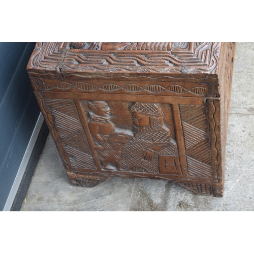 503 - Nigerian hard wood carved coffer / blanket box with carved figural decoration amongst traditional sc... 