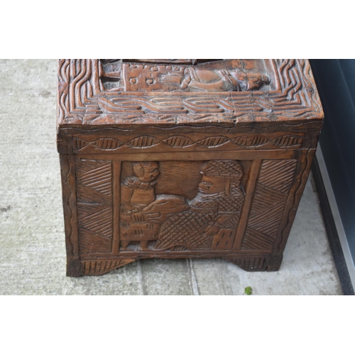 503 - Nigerian hard wood carved coffer / blanket box with carved figural decoration amongst traditional sc... 