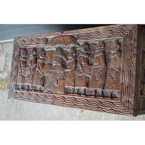 503 - Nigerian hard wood carved coffer / blanket box with carved figural decoration amongst traditional sc... 