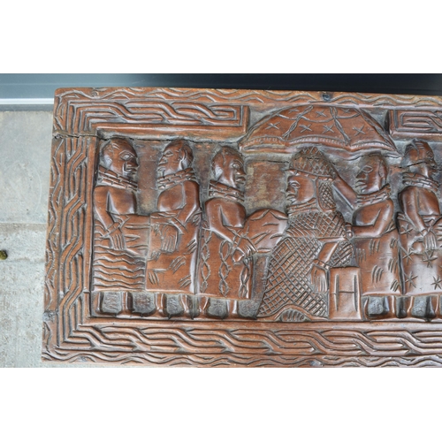 503 - Nigerian hard wood carved coffer / blanket box with carved figural decoration amongst traditional sc... 