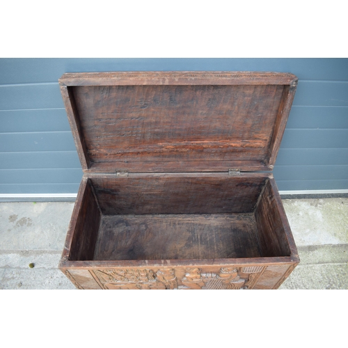 503 - Nigerian hard wood carved coffer / blanket box with carved figural decoration amongst traditional sc... 