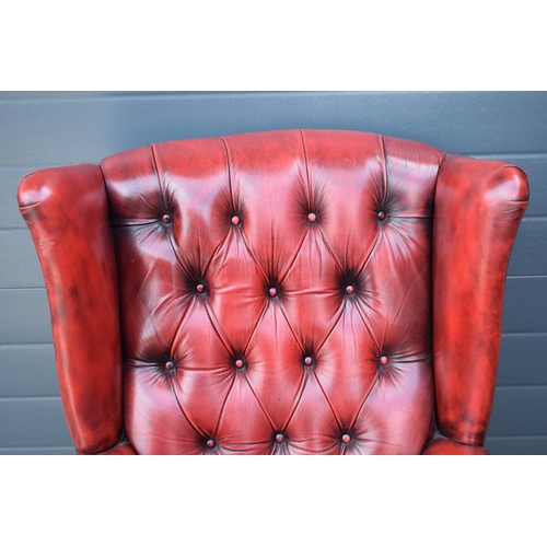 504 - Queen Anne revival chesterfield wingback armchair, in red leather with button back, raised on front ... 