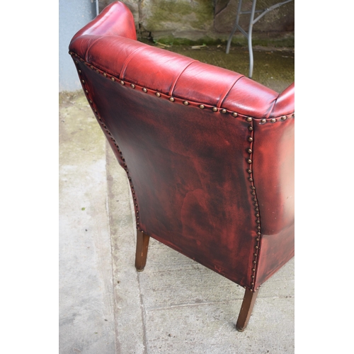 504 - Queen Anne revival chesterfield wingback armchair, in red leather with button back, raised on front ... 