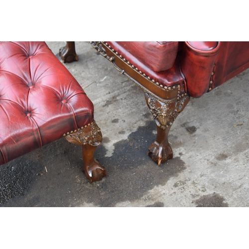 505 - Queen Anne revival chesterfield wingback armchair, in red leather with button back, raised on front ... 