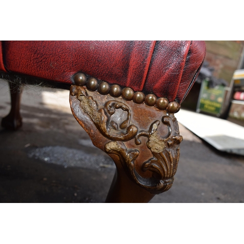 505 - Queen Anne revival chesterfield wingback armchair, in red leather with button back, raised on front ... 