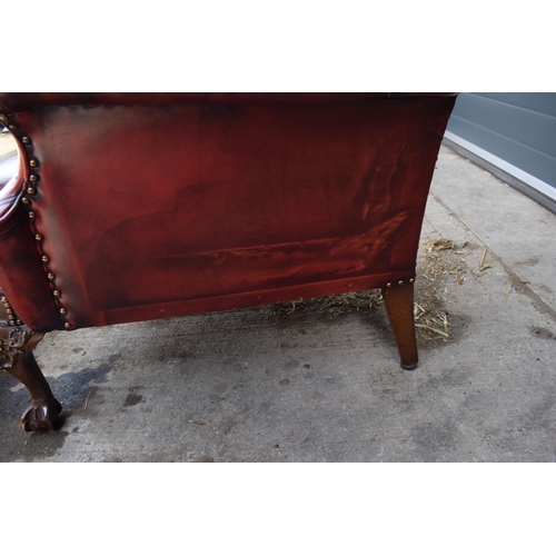 505 - Queen Anne revival chesterfield wingback armchair, in red leather with button back, raised on front ... 