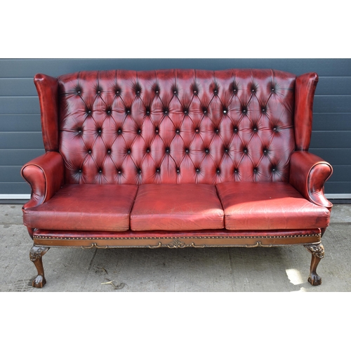 506 - Queen Anne revival chesterfield wingback three seater sofa, with high back, in red leather with butt... 