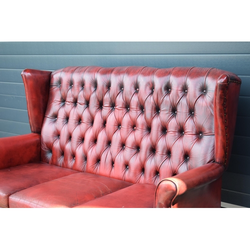 506 - Queen Anne revival chesterfield wingback three seater sofa, with high back, in red leather with butt... 