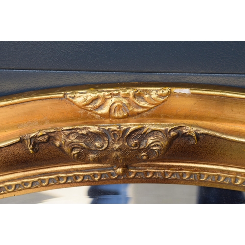 507 - Reproduction oval gilt mirror with bevel edged mirror, 86x66cm.