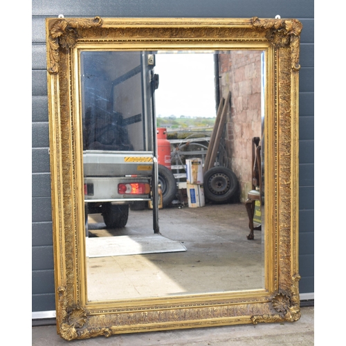 510 - Quality reproduction gilded rectangular mirror, with bevel edged plate, in ornate composite gilded f... 