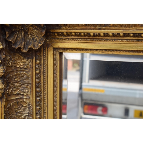 510 - Quality reproduction gilded rectangular mirror, with bevel edged plate, in ornate composite gilded f... 