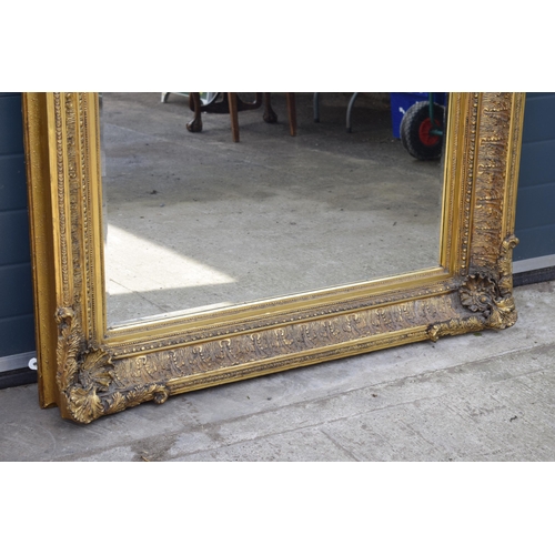 510 - Quality reproduction gilded rectangular mirror, with bevel edged plate, in ornate composite gilded f... 