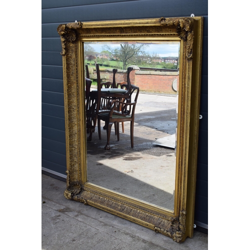 510 - Quality reproduction gilded rectangular mirror, with bevel edged plate, in ornate composite gilded f... 