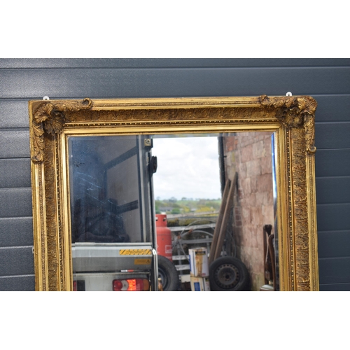 510 - Quality reproduction gilded rectangular mirror, with bevel edged plate, in ornate composite gilded f... 