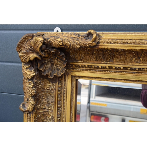 510 - Quality reproduction gilded rectangular mirror, with bevel edged plate, in ornate composite gilded f... 