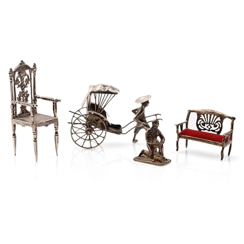 313 - A collection of novelty silver items to include a scene of a gentleman pulling a cart, a miniatures ... 