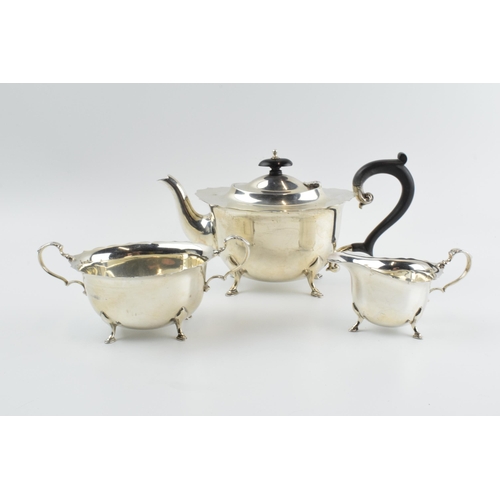 290 - Hallmarked silver tea set to include a teapot, milk and sugar with ebonised wooden handle and finial... 