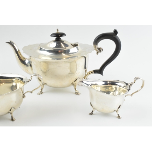 290 - Hallmarked silver tea set to include a teapot, milk and sugar with ebonised wooden handle and finial... 