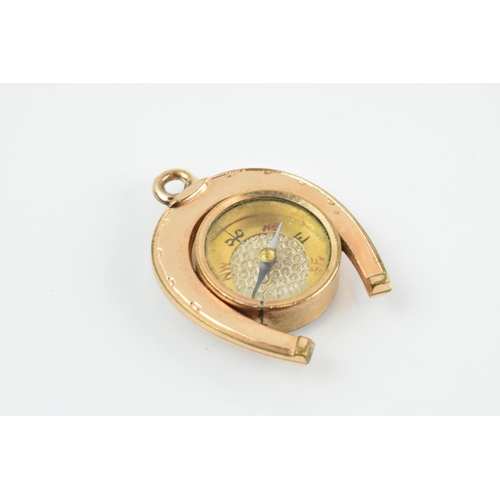 465 - Gold plated horseshoe watch fob with agate face and compass, 3.5cm long.