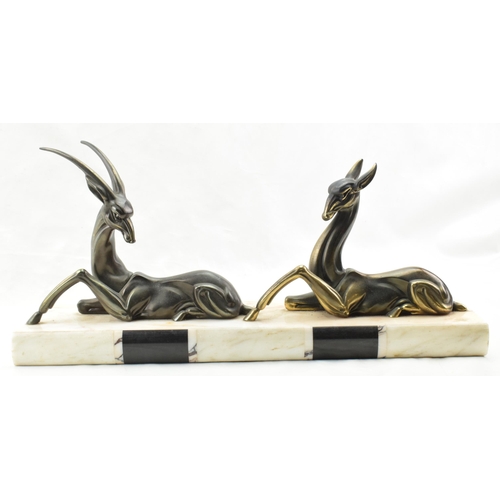 492 - French Art Deco spelter figures of a gazelle and a deer mounted on a marble base, 50cm long.