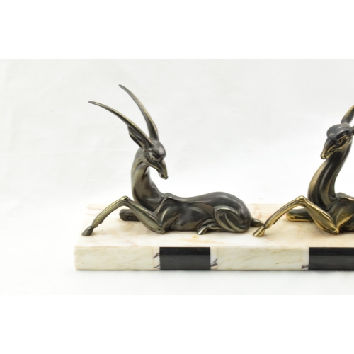 492 - French Art Deco spelter figures of a gazelle and a deer mounted on a marble base, 50cm long.