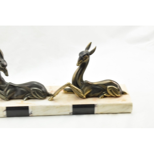 492 - French Art Deco spelter figures of a gazelle and a deer mounted on a marble base, 50cm long.