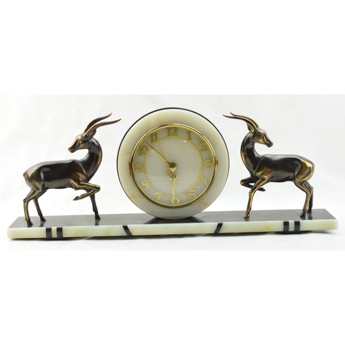 493 - French Art Deco mantle clock, flanked by gazelles with raised legs, 61cm long.