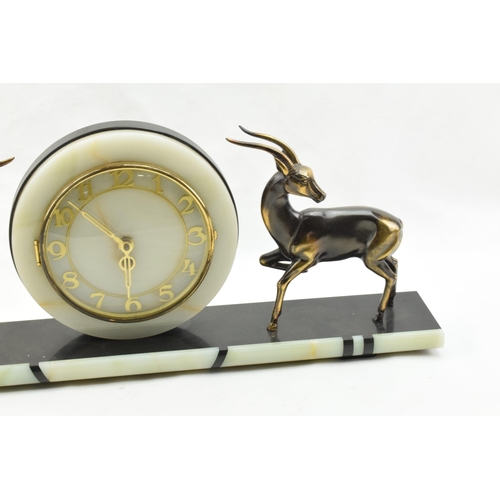 493 - French Art Deco mantle clock, flanked by gazelles with raised legs, 61cm long.