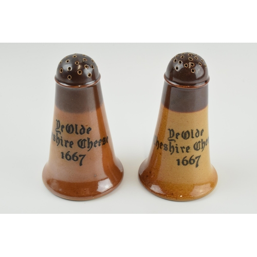 124 - A near pair of Doulton Lambeth 'Ye Olde Cheshire Cheese 1667' pepperettes, 11cm tall (2).