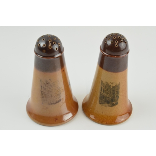 124 - A near pair of Doulton Lambeth 'Ye Olde Cheshire Cheese 1667' pepperettes, 11cm tall (2).