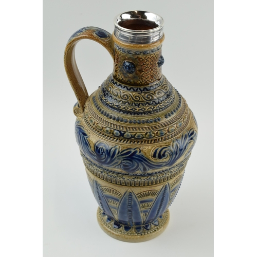 126 - Doulton Lambeth ovoid jug with curved handle and white metal mount, with blue floral design, signed ... 