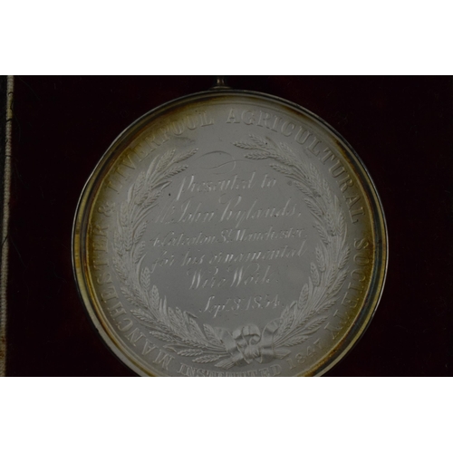 177 - Cased 'Liverpool and Manchester Agricultural Society' medallion, dated 8th September 1854, in white ... 