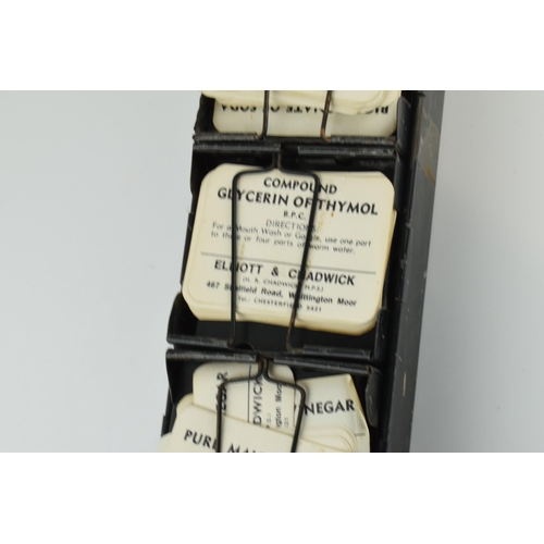 254 - 'The Alchemist Label Rack' with 6 sections for holding paper bottle labels, 43.5cm long, with some o... 